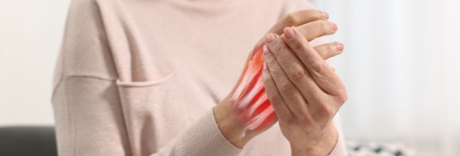 Woman holding her hand due to chronic joint pain
